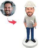 Engineering-Teamleiter mit Blaupausen Kundenspezifische Bobbleheads mit graviertem Text Tragen Sie einen Schutzhelm
